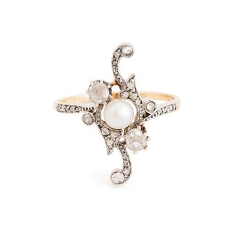 A platinum and gold ring set with a pearl and rose-cut diamonds.