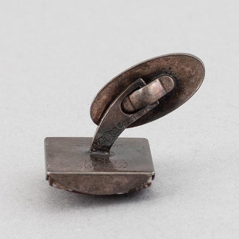 A porphyry mantle clock, salt cellar and cullflinks, 20th century.