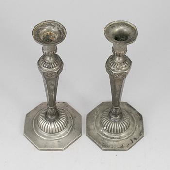 A pair of 18th century pewter candlesticks.