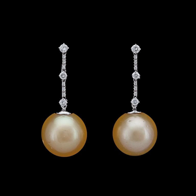 A pair of cultured golden South sea pearl, 15,8 mm, and brilliant cut diamond earrings, tot. app. 0.50 cts.