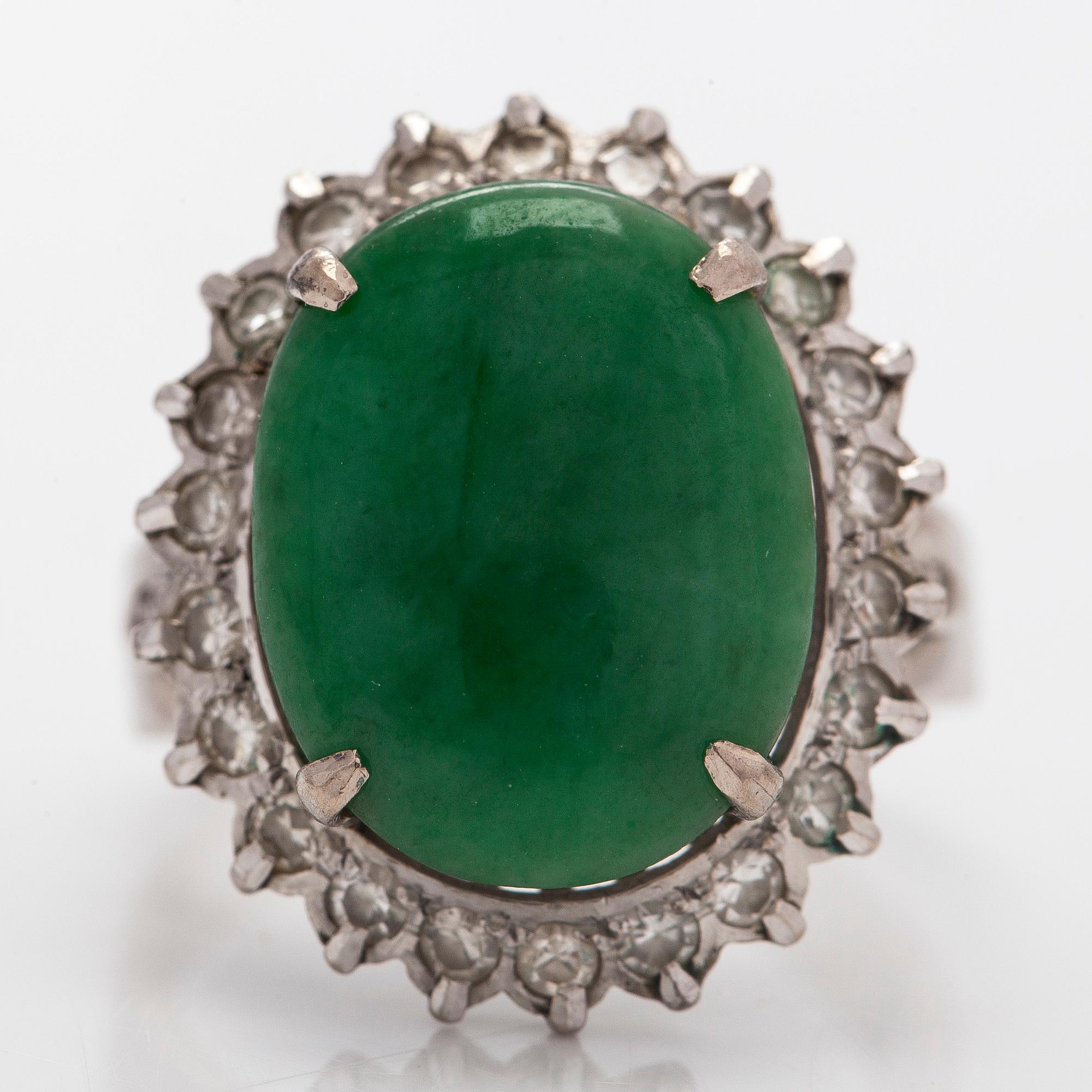 A palladium-plated silver ring with cabochon-cut jadeite and diamonds.