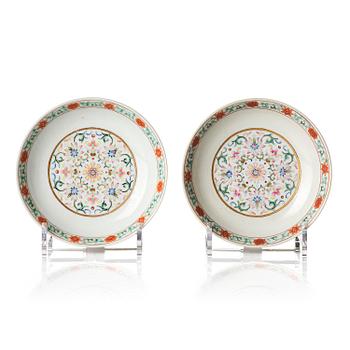 828. A pair of yellow-ground famille rose 'lotus' dishes, Qing dynasty, Jiaqing red seal mark and of the period (1796-1820).