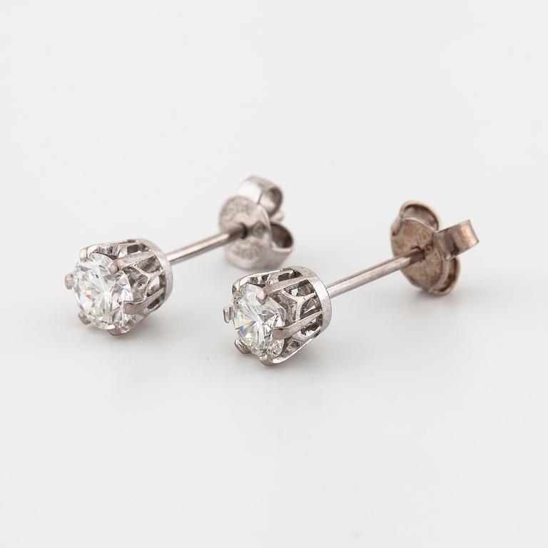 A pair of brilliant cut diamond earrings.