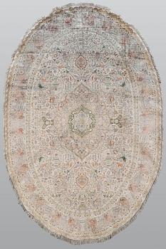 A figural Oriental silk carpet, approx. 273 x 180 cm.