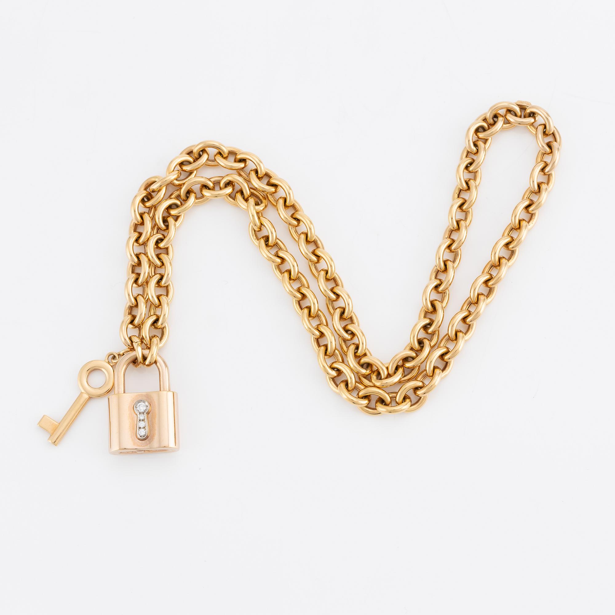 Collier, 18K guld, Gübelin, med 
berlock/hänge i form av lås Gübelin med briljantslipade diamanter.