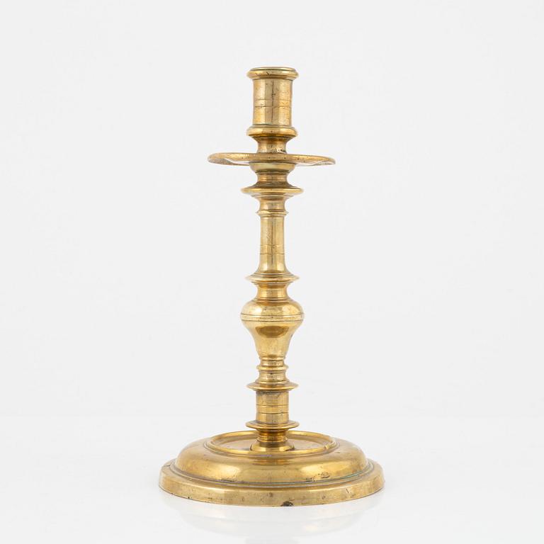 A brass candlestick, 18th century.