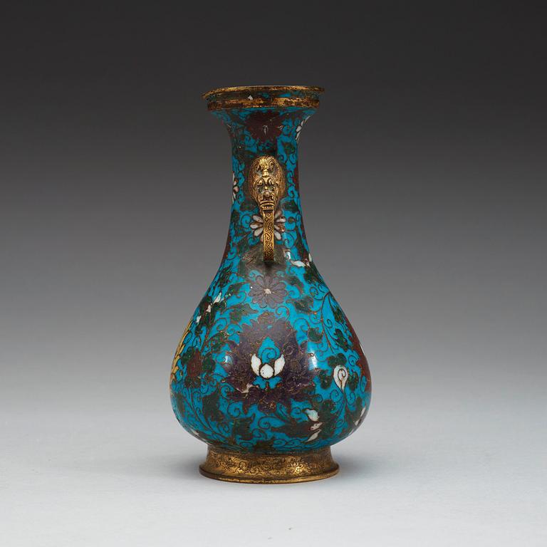 A cloisonné vase decorated with lotus-scrolls, and dragon- shaped gilded handles, Ming Dynasty (1368-1644).