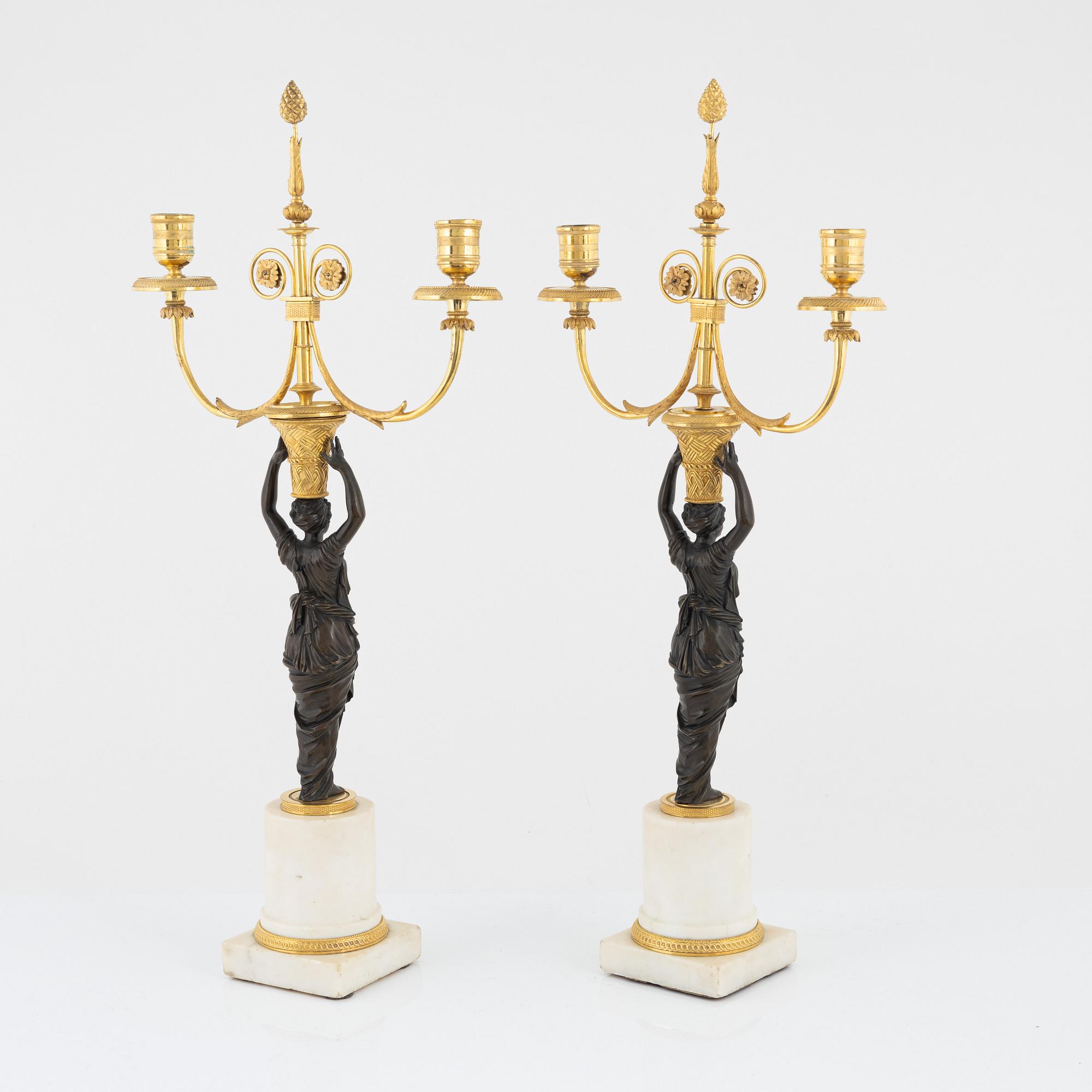 A pair of French Louis XVI ormolu, marble, and patinated bronze two-branch candelabra, late 18th century.