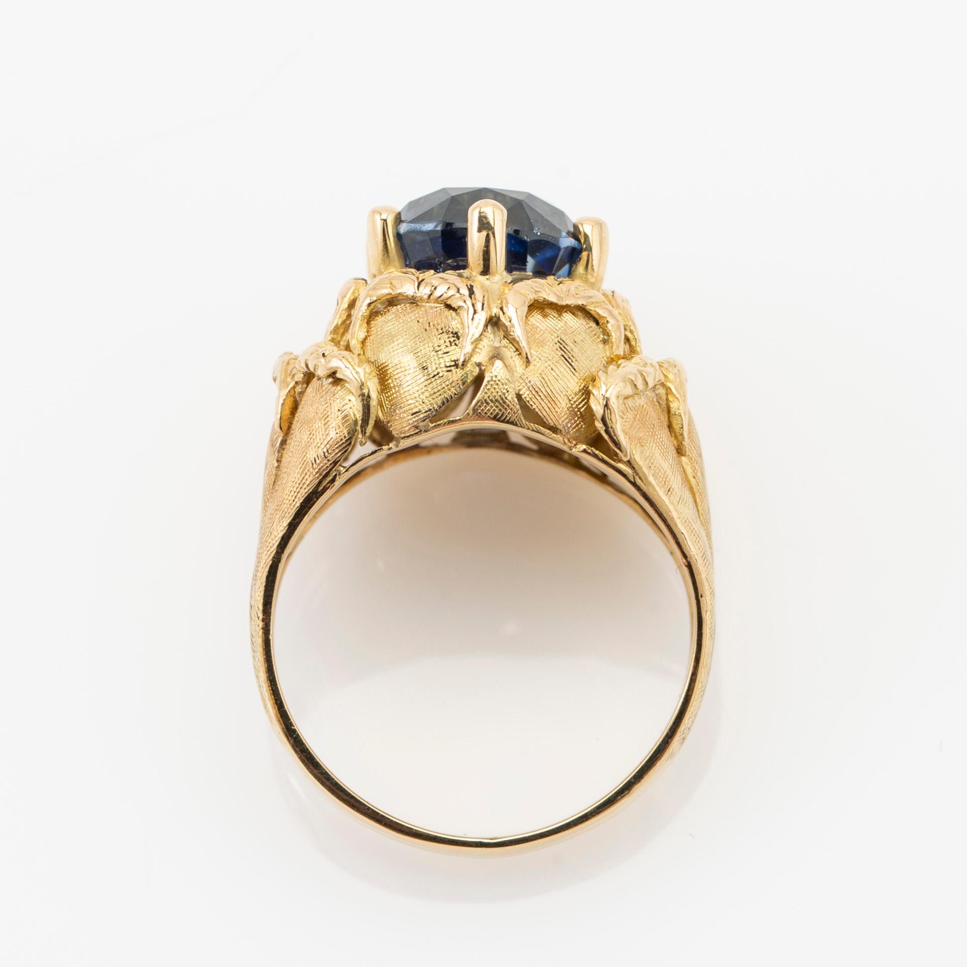 Ring, 18k gold with blue stone, possibly sapphire.