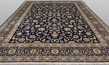 A Keshan carpet, signed, approx. 430 x 320 cm.