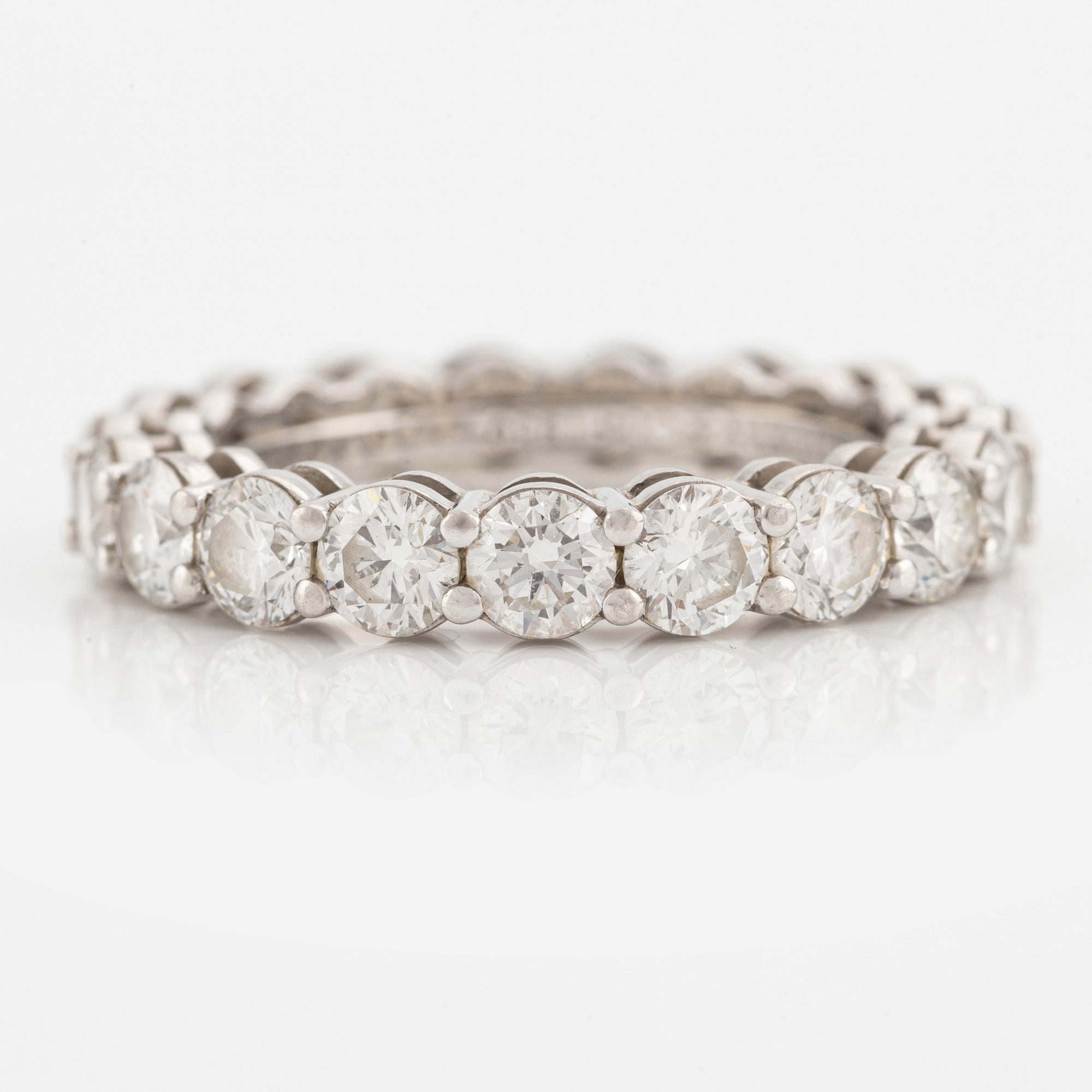 A platinum Tiffany & Co eternity ring set with round brilliant-cut diamonds.