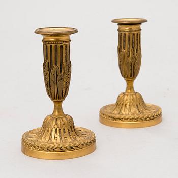 A pair of French, late 19th Century brass candleholders.