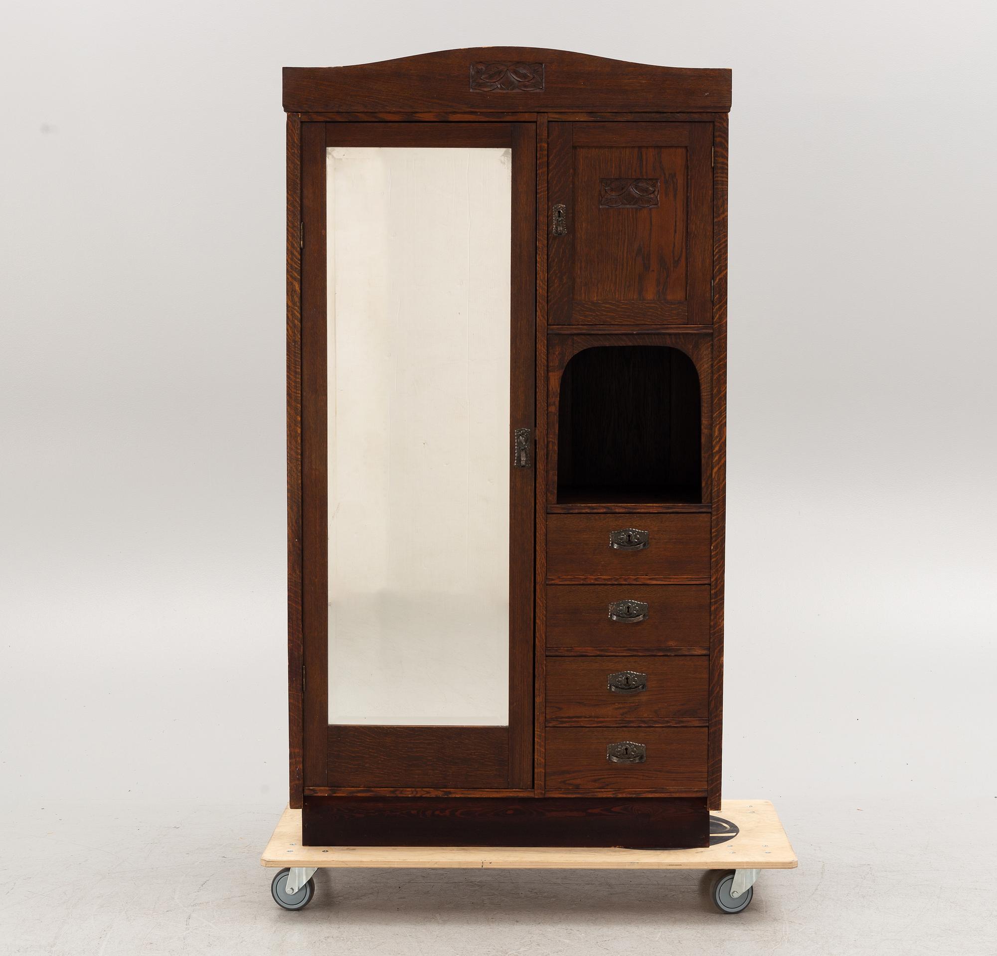 An early 20th century oak cabinet with drawers.