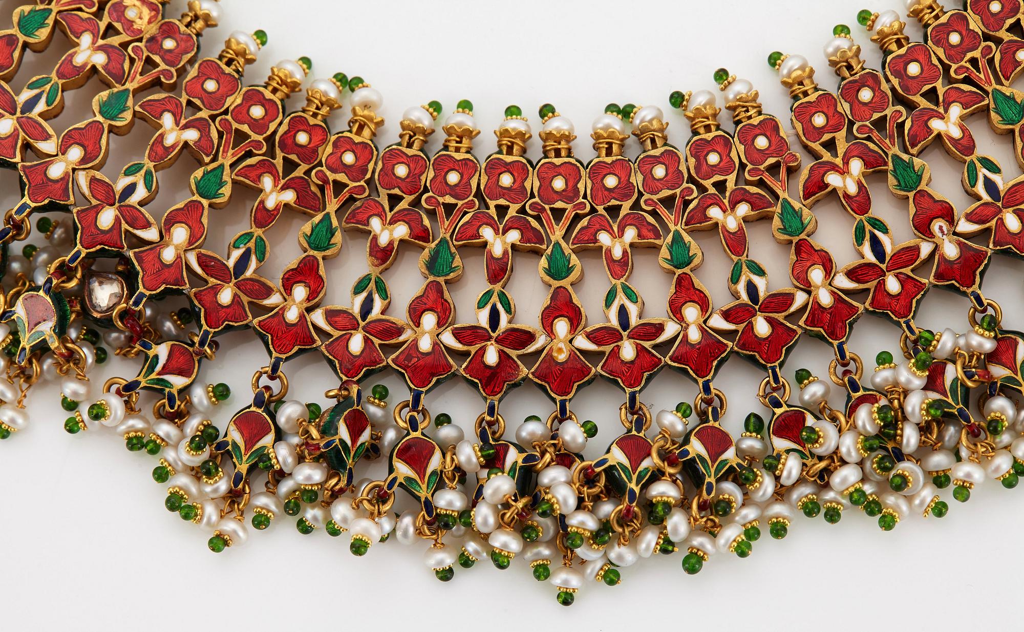 An Indian demi parure comprising a necklace and a pair of earrings.