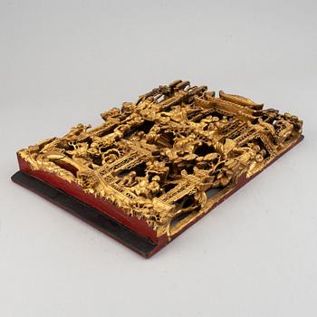 A carved and gilded wooden and metal panel, late Qing dynasty, 19th Century.