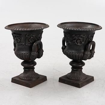A pair of cast-iron planters, 20th century.
