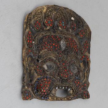 A stone inlay mask, Nepal, early 20th century.