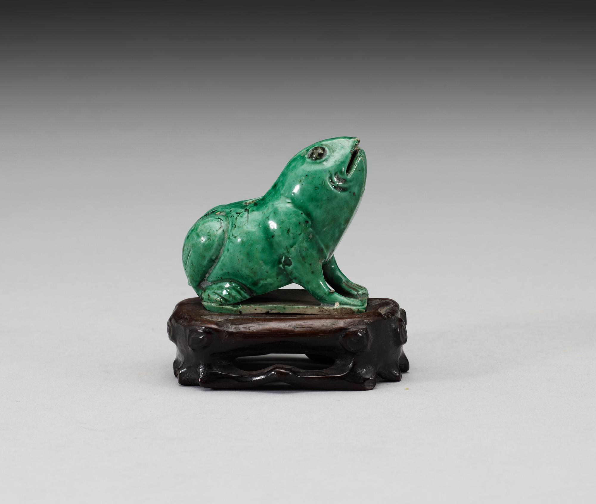 A green glazed biscuit water dropper, in the shape of a frog, Qing dynasty, Kangxi (1662-1722).