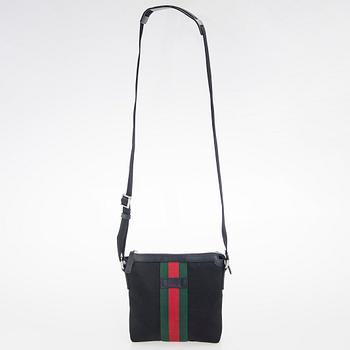 Gucci, a "Techno Canvas Web Messenger" bag.