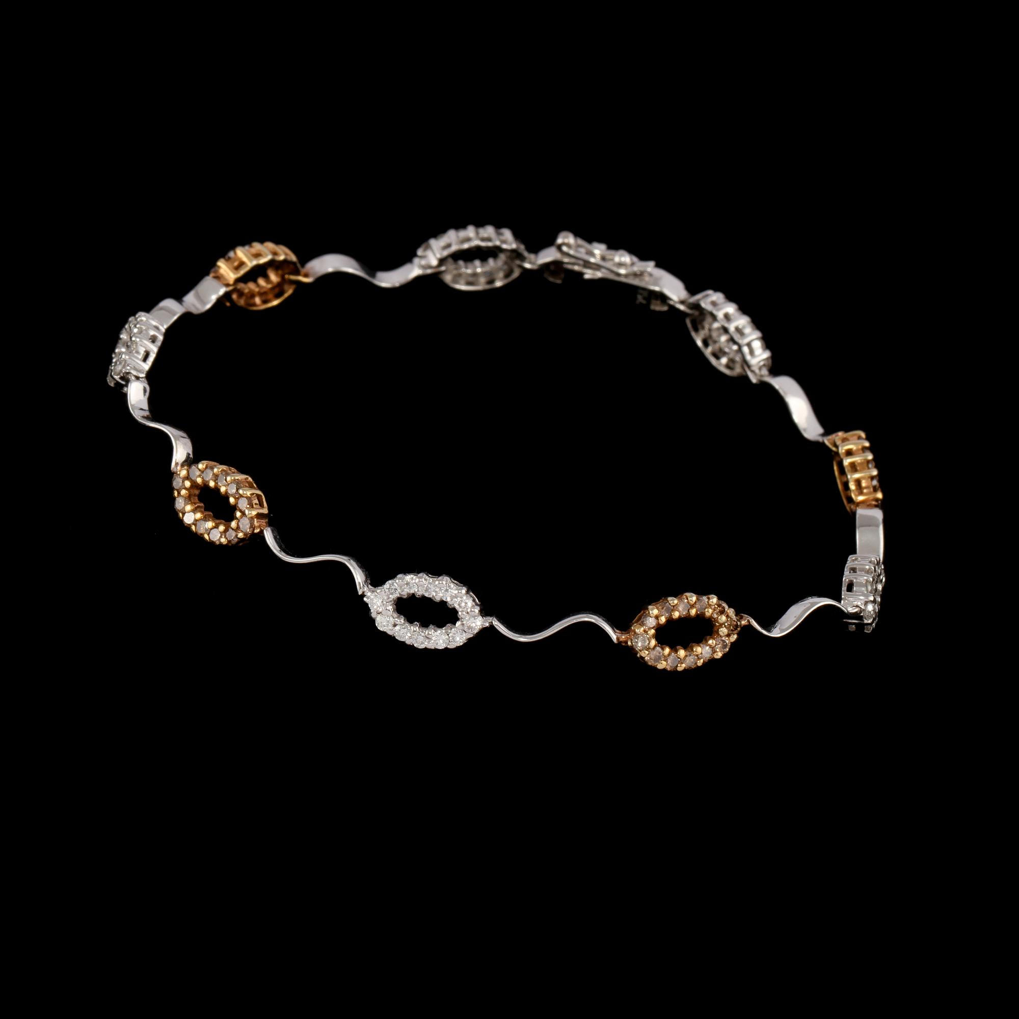 ARMBAND, 18k guld med briljantslipade diamanter, 0.7 ct samt bruna briljantslipade diamanter, 0.59 ct. Vikt 7 g.