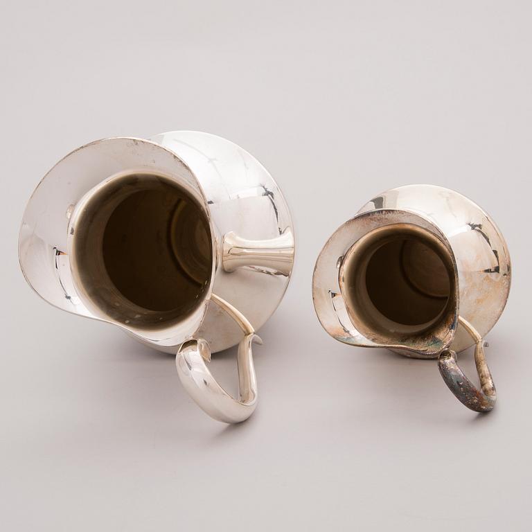 Two late 20th century white metal tankards.