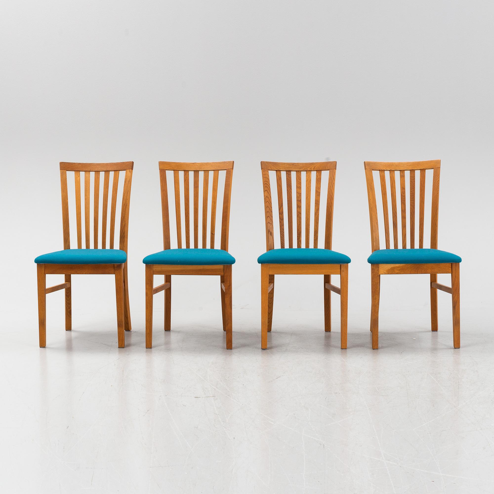 A set of four oak chairs from around the year 2000.
