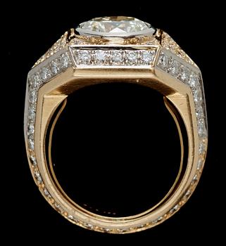 A brilliant-cut diamond ring. Center stone circa 2.95 cts. Surrounding diamonds total carat weight circa 1.50 cts.