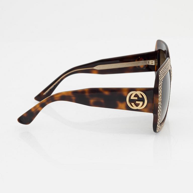 Gucci, a pair of black plastic and rhinestone sunglasses.