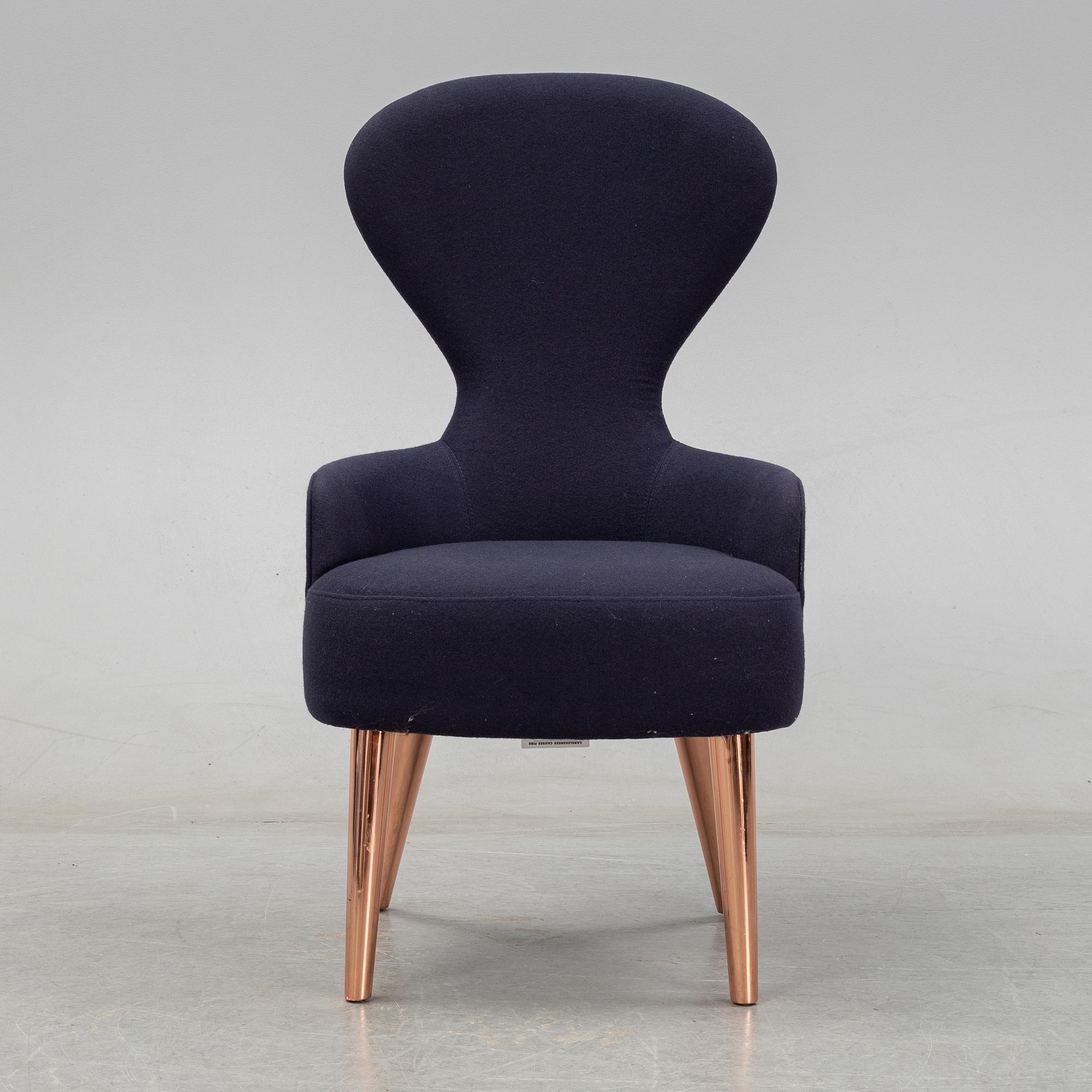 A Tom Dixon "Wingback Dining Chair" from Tom Dixon.