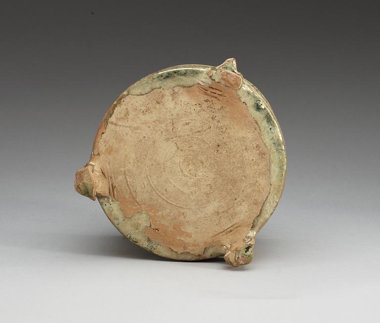 A green glazed tripod censer, Han dynasty (206 BC – 220 AD).