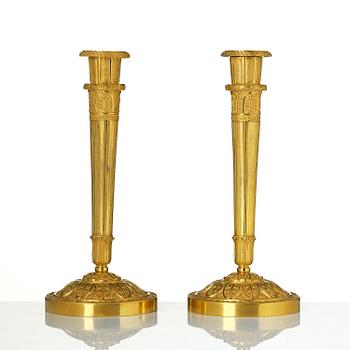 A pair of Empire ormolu candlesticks.