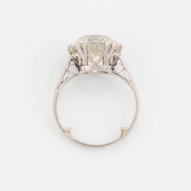 A platinum ring set with a cushion-formed old-cut diamond.