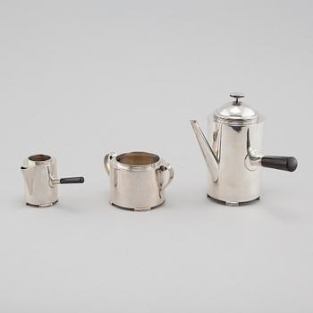 A silver coffee pot, a creamer and a sugar bowl by C F Carlman in Stockholm, 1937 and 1945.