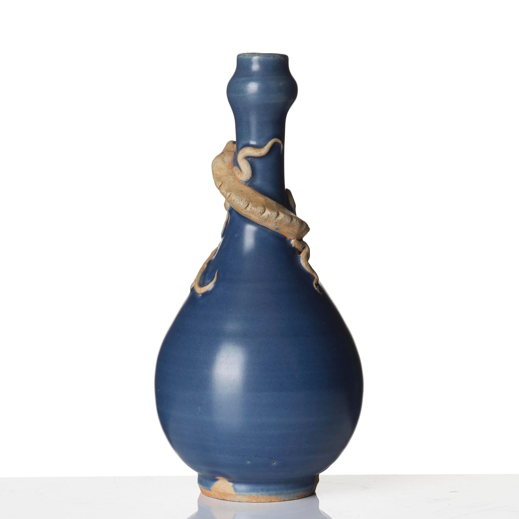 A blue glazed vase with a dragon in relief, late Ming dynasty/early Qing dynasty.