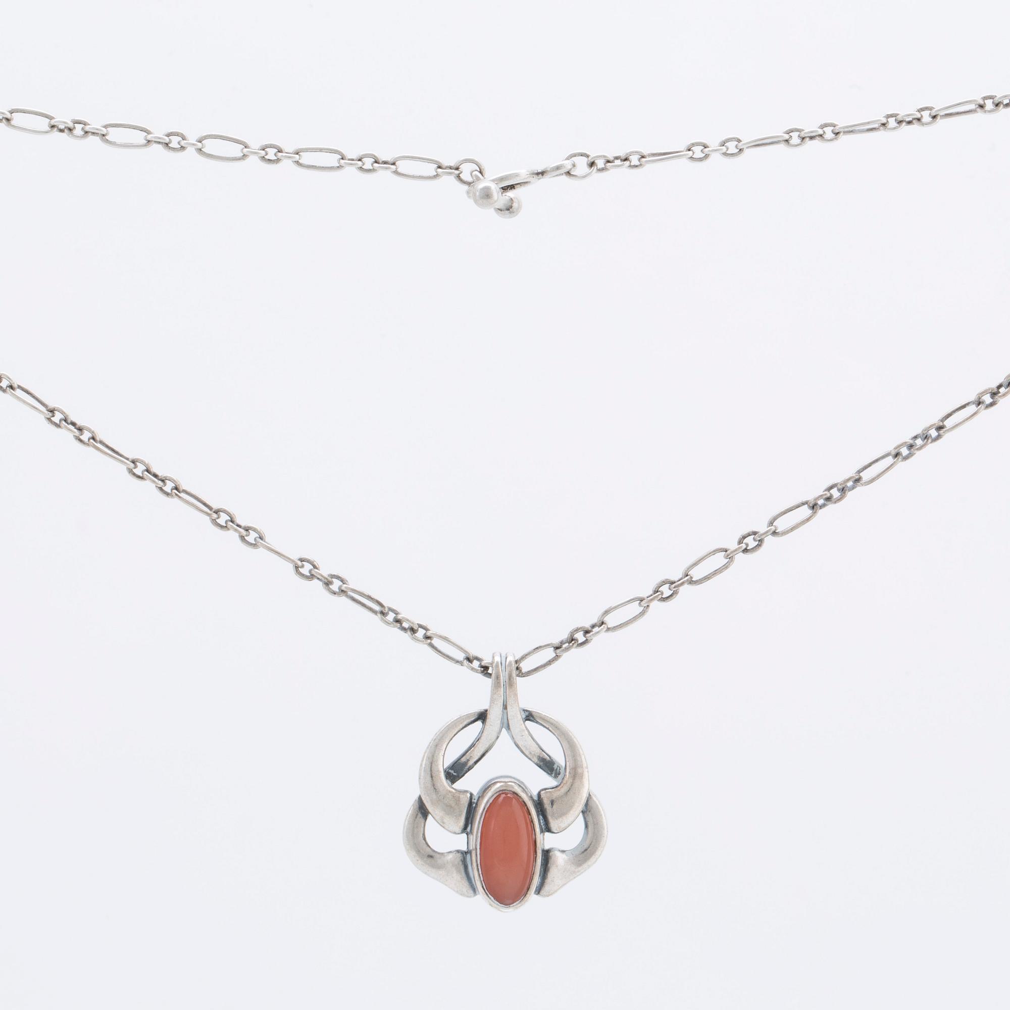 A silver and moonstone jewellery set consisting of necklace and earrings by Georg Jensen, jewellery of the year 2006.