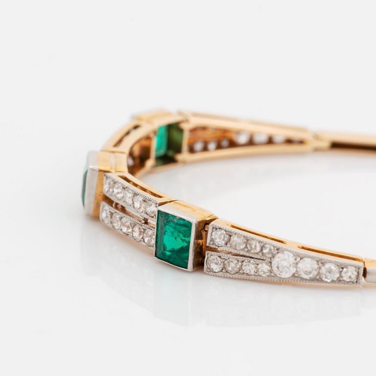 An 18K gold and platinum bracelet set with step-cut emeralds and old- and eight-cut diamonds.