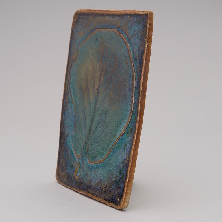 A stoneware art plate signed TM.