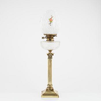 A brass and glass column shaped paraffin lamp, end of the 19th Century.