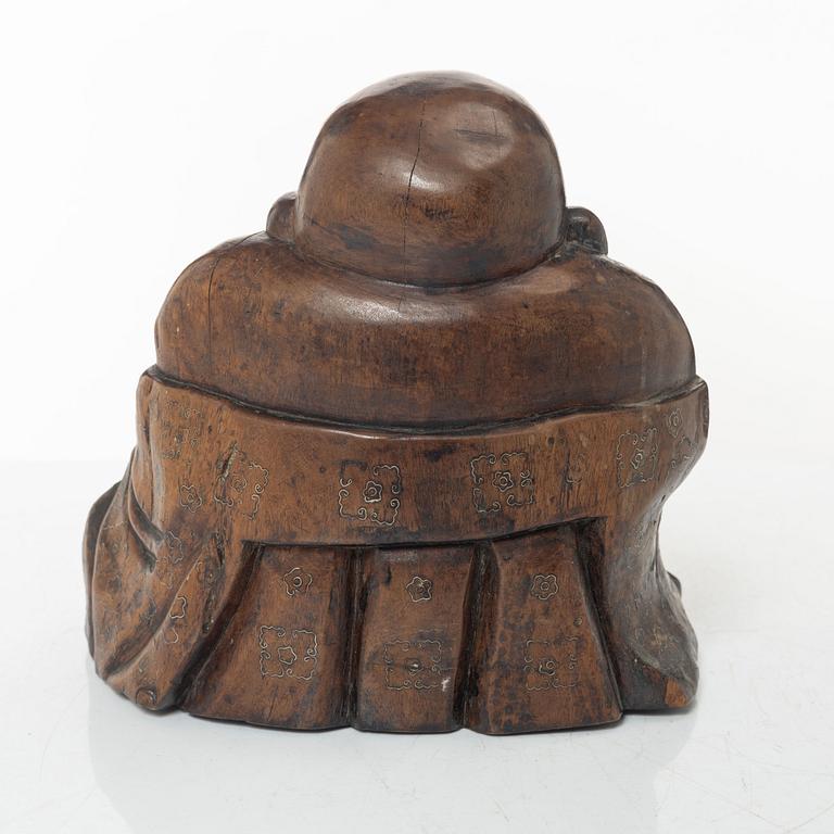 A Chinese wooden figure of Budai with silver inlays, Qing dynasty (1644-1912).