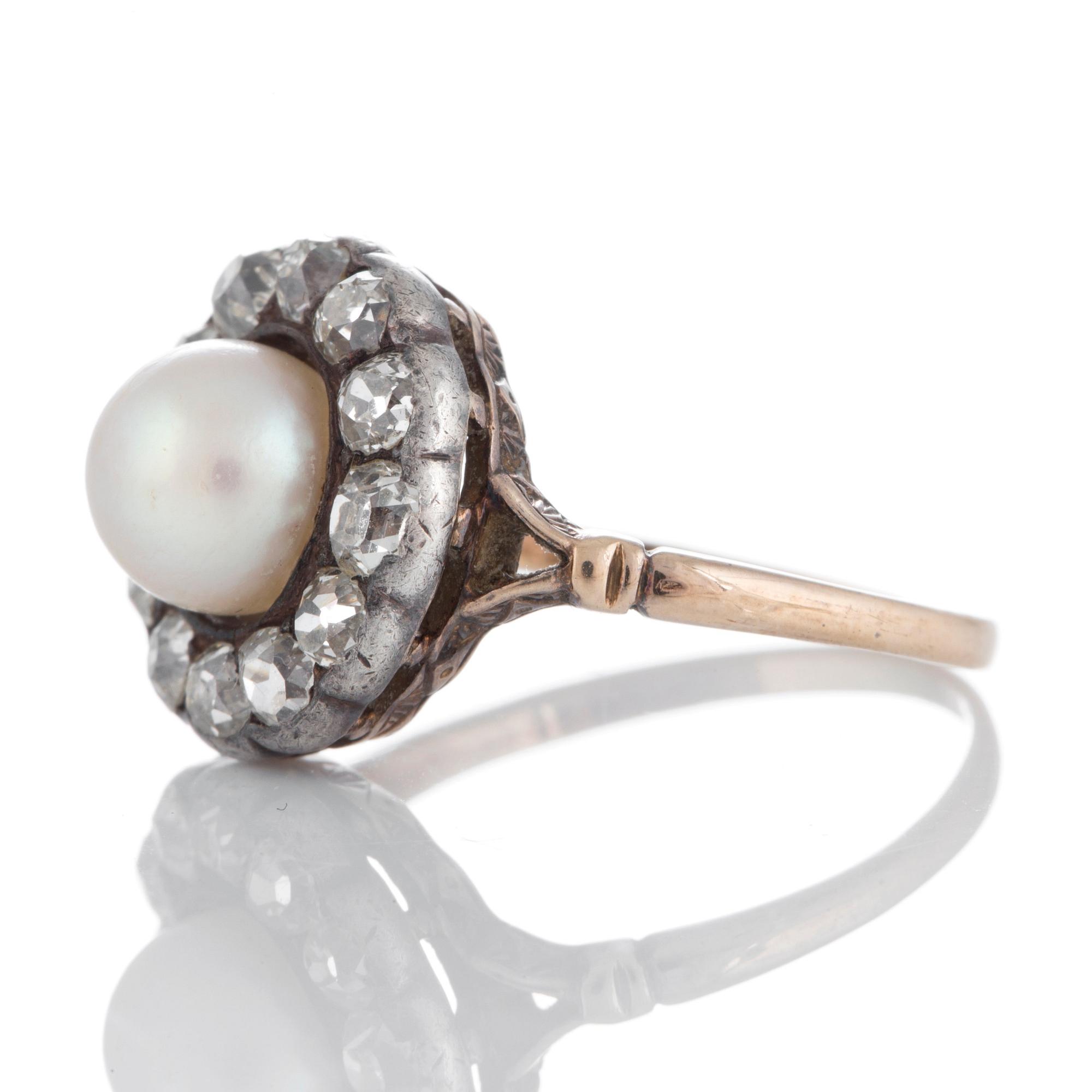 A pearl ring set with old-cut diamonds.