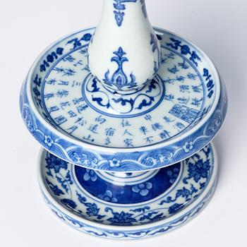 A pair of blue and white pricket candle sticks, with a poem, Qing dynasty with a Qianlong mark and of the period.