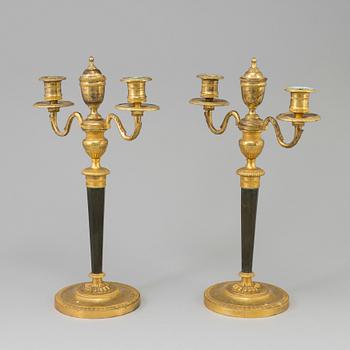 A pair of French Directoire late 18th century ormolu candelabra for three candles.
