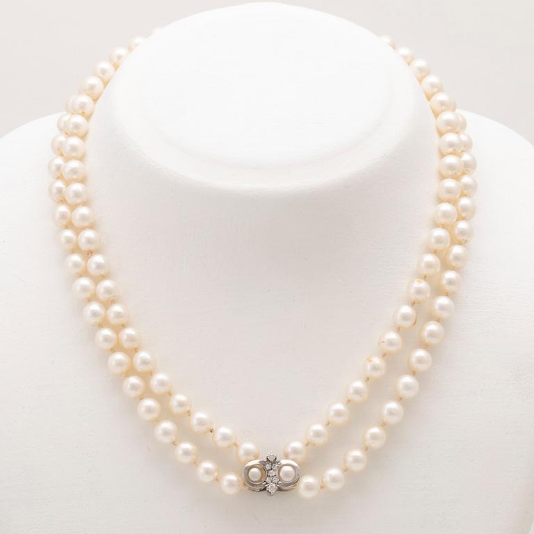 A necklace with cultured pearls and clasp in 18K white gold with round brilliant-cut diamonds, Hellström & Åhrling 1981.