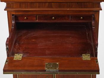 A late Gustavian mahogany column-cabinet, Stockholm, circa 1800.