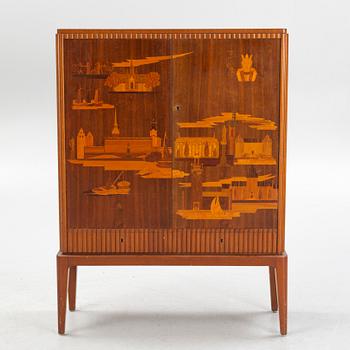 Erik Mattsson, skåp, "Stockholm" utfört av  Birger Ekman, Mjölby Intarsia för AB Harry Carlsson Stockholm, 1940-tal.
