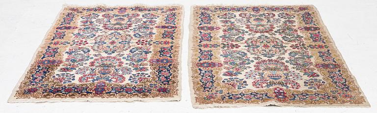 A pair of similar Kirman rugs, south Persia, c. 147 x 94 and 154 x 96 cm.