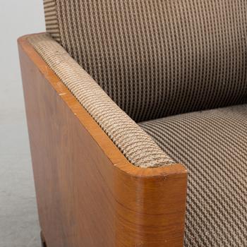 An Art Deco armchair veneered with walnut from the 1930's.