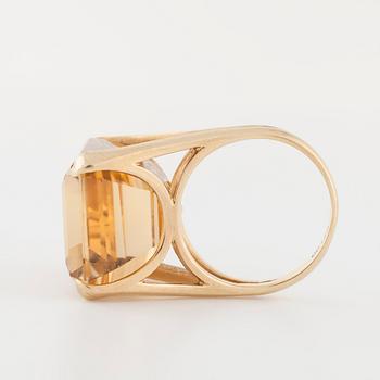 An emerald cut citrin ring.