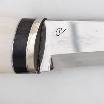 A reindeer horn knife with buffalo inlays by Bertil Fällman, signed.