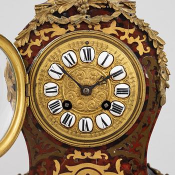 A Louis XV-style mantel clock, late 19th century.